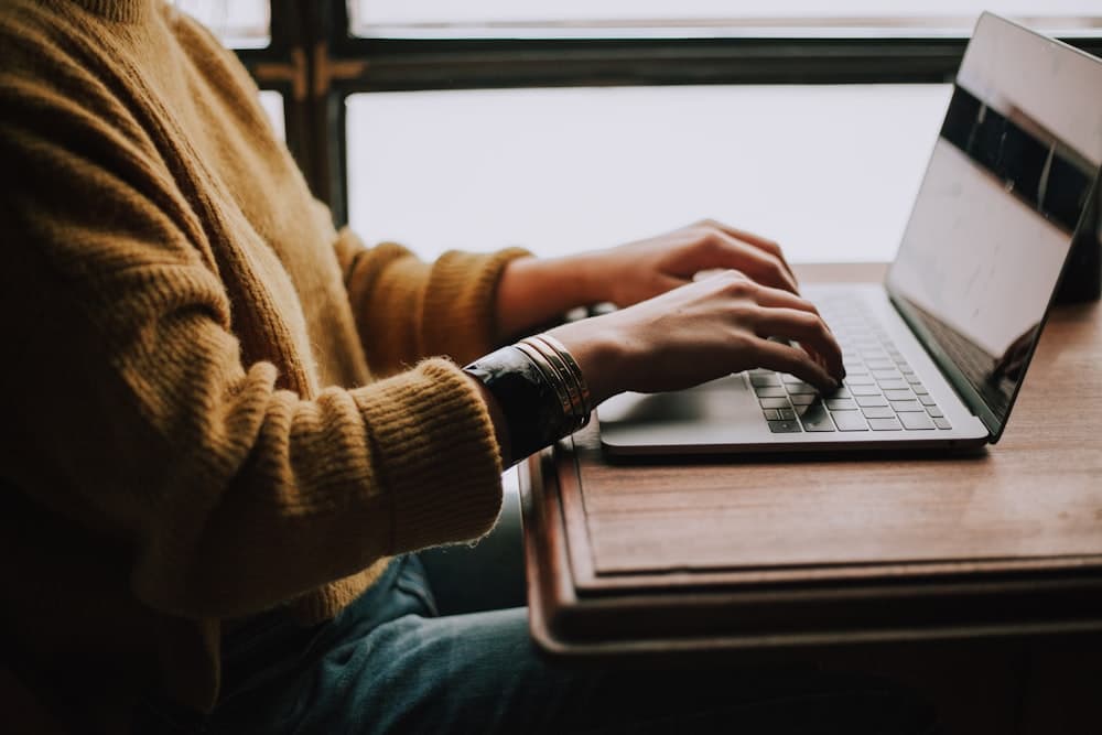 A learner working on a laptop during a practical AI training session